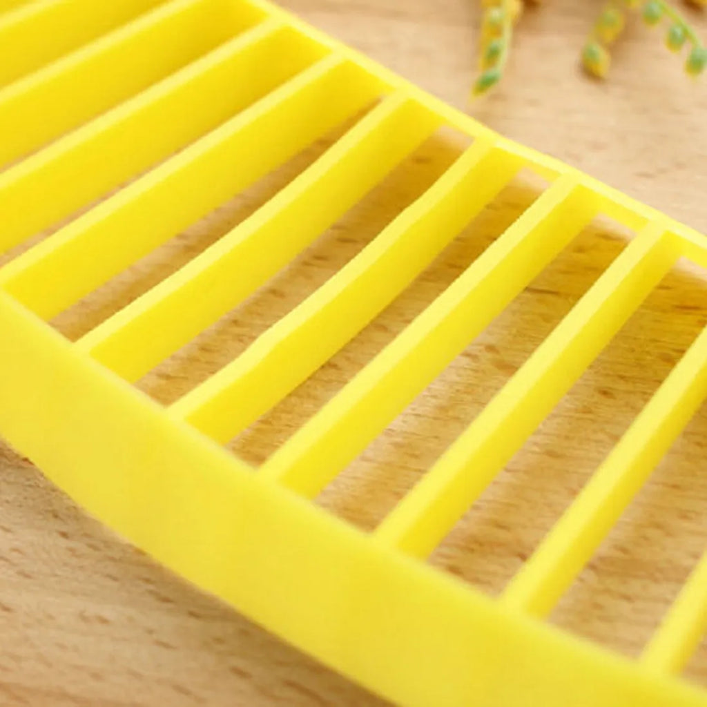 Yellow banana cutter slicer made from food-grade PP plastic, 25 x 7 x 1.4 cm, on a light background