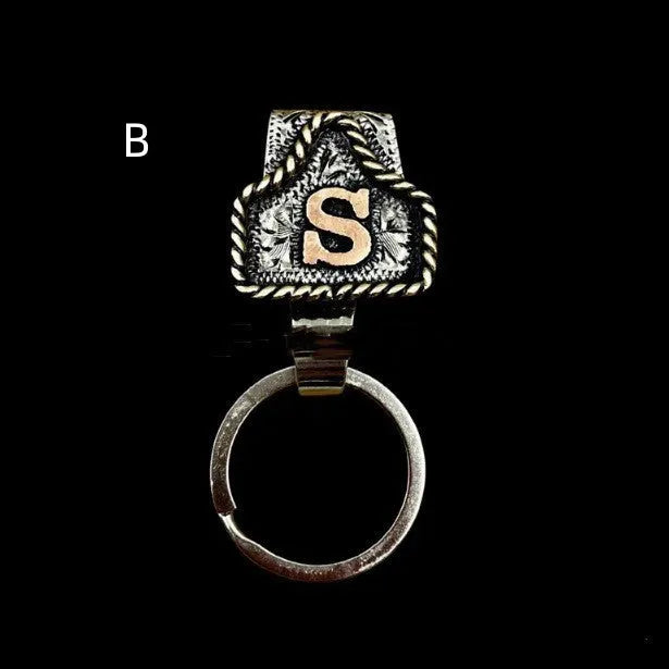 Handmade metal cow tag belt key holder keychain with a lettered tag and clip.