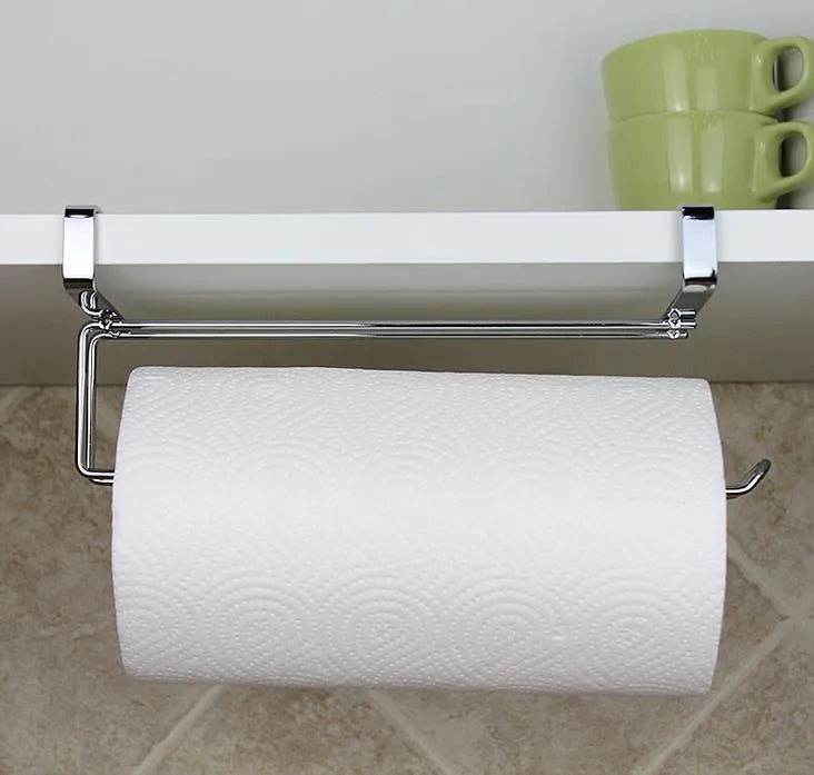 Silver stainless steel paper towel rack hanging on a cabinet door.