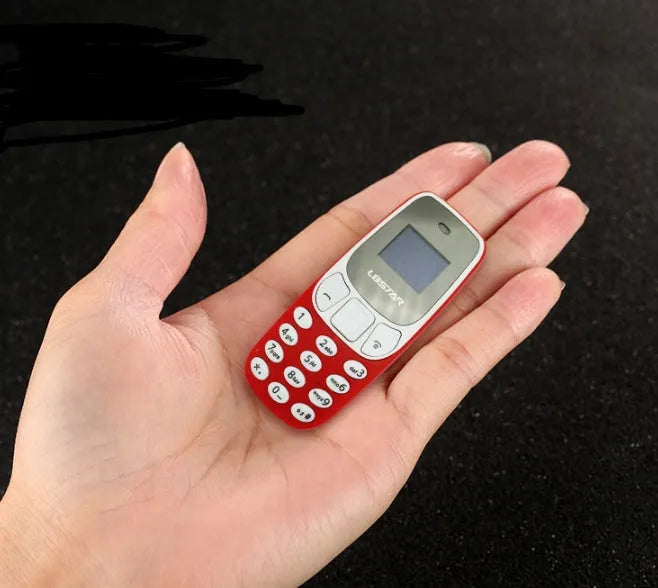 Ultra-small miniature thumb phone with 0.66-inch OLED display and keypad, smaller than a lighter