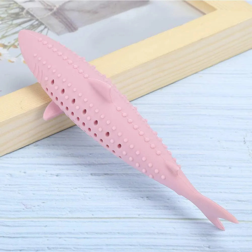 Green silicone fish-shaped cat chew toy with side holes on a white background.
