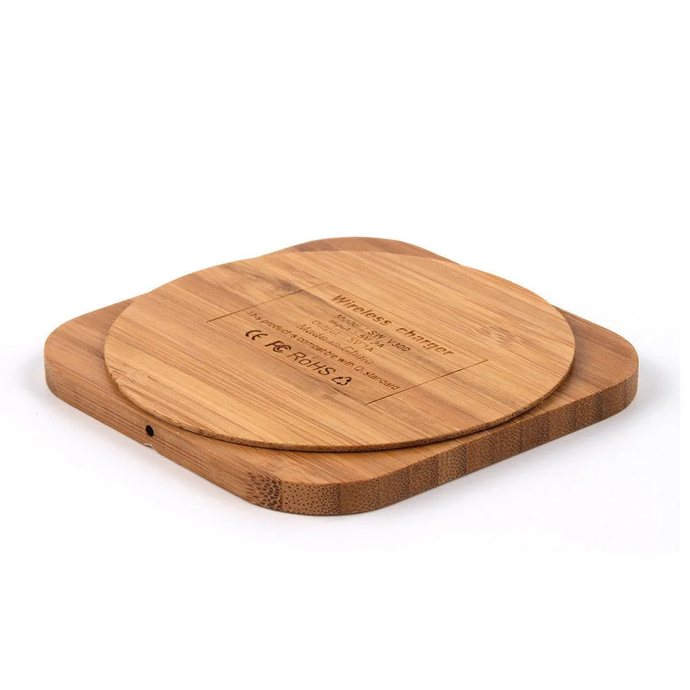 Square wooden bamboo 5W QI wireless charging pad for smartphones on a desk.