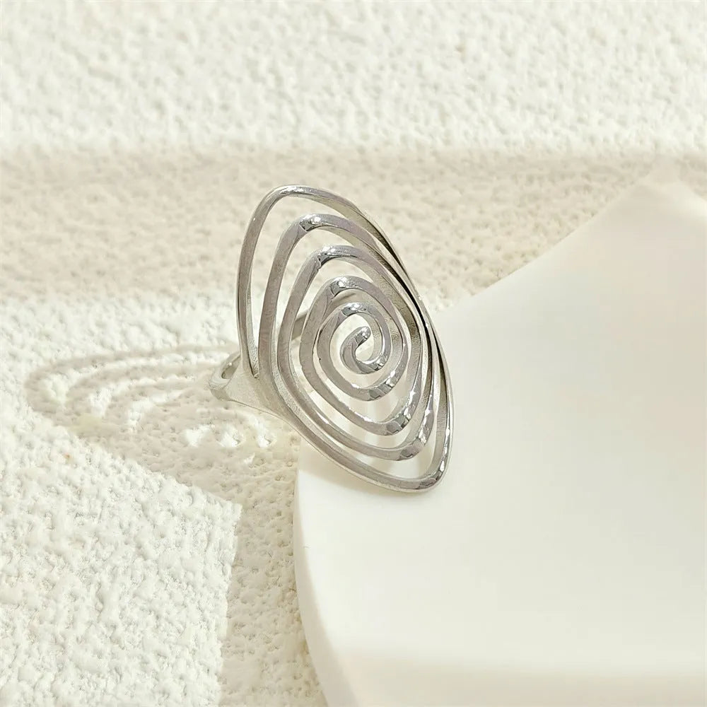 Stainless steel exaggerated circle geometric ring in gold colour, adjustable opening, front view.