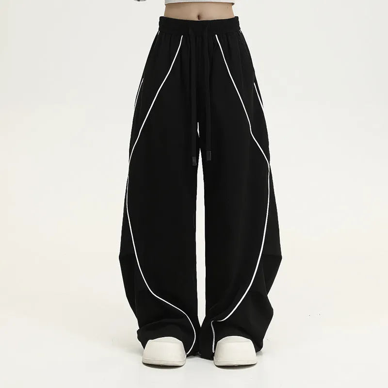 Black pleated hip hop trousers with wide-leg design and striped pattern