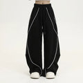 Black pleated hip hop trousers with wide-leg design and striped pattern