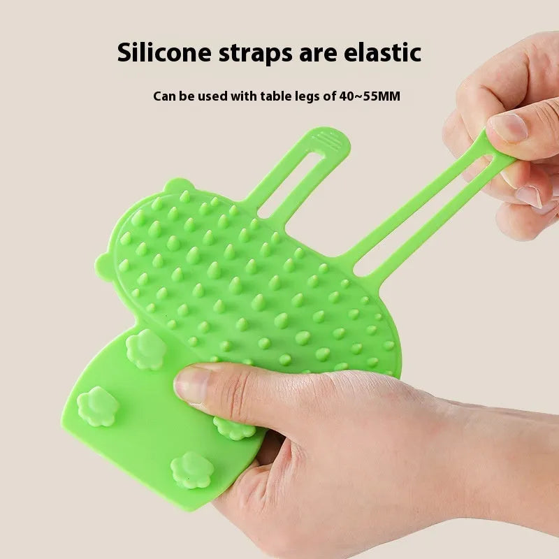 Adjustable silicone cat scratching brush mounted on table leg with rounded comb teeth for grooming