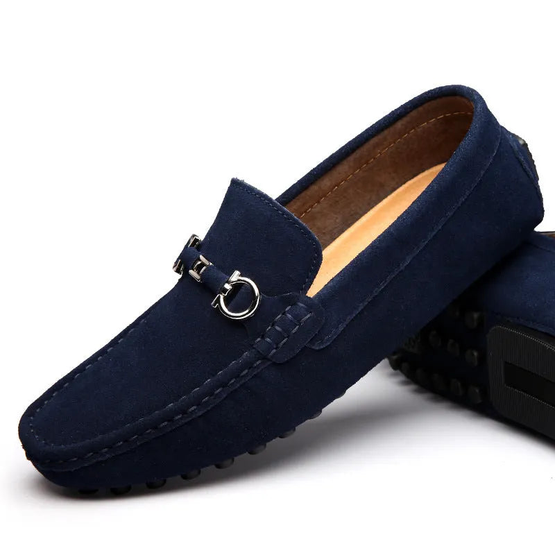 Men's black cowhide leather slip-on shoes with square toe and visible stitching on a rubber sole.