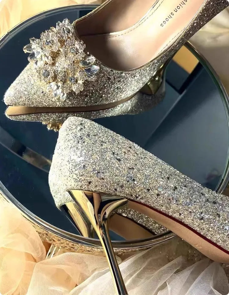 Champagne coloured pointed toe bridal shoes with rhinestone decoration on a fine heel.