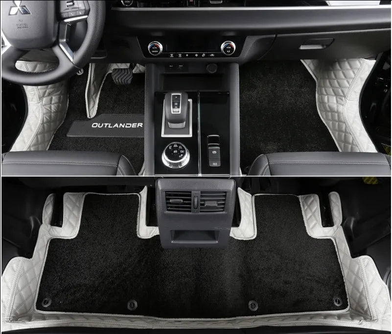 Custom black floor mats fitted in a 2023 Mitsubishi Outlander footwell