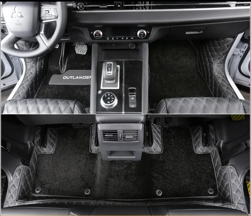 Custom black floor mats fitted in a 2023 Mitsubishi Outlander footwell