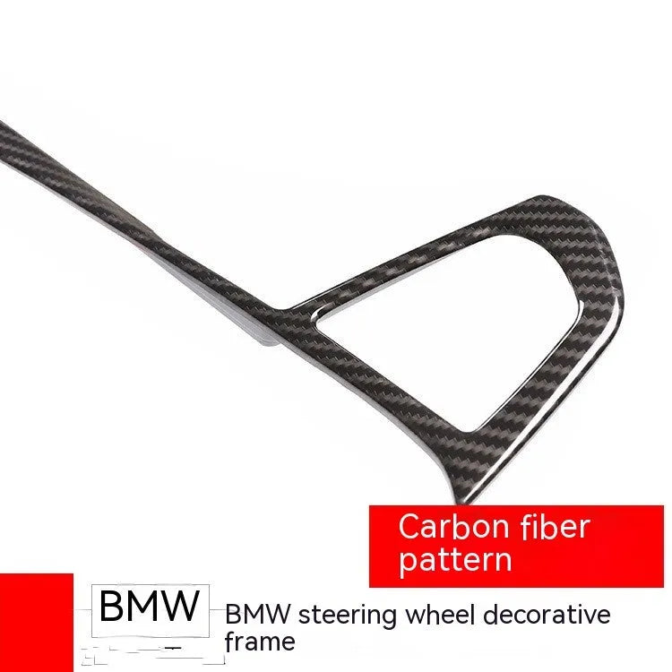 BMW steering wheel button frame decoration with carbon fibre pattern on black ABS.