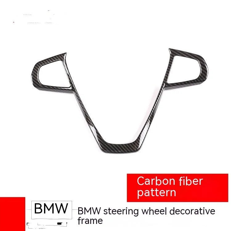 BMW steering wheel button frame decoration with carbon fibre pattern on black ABS.