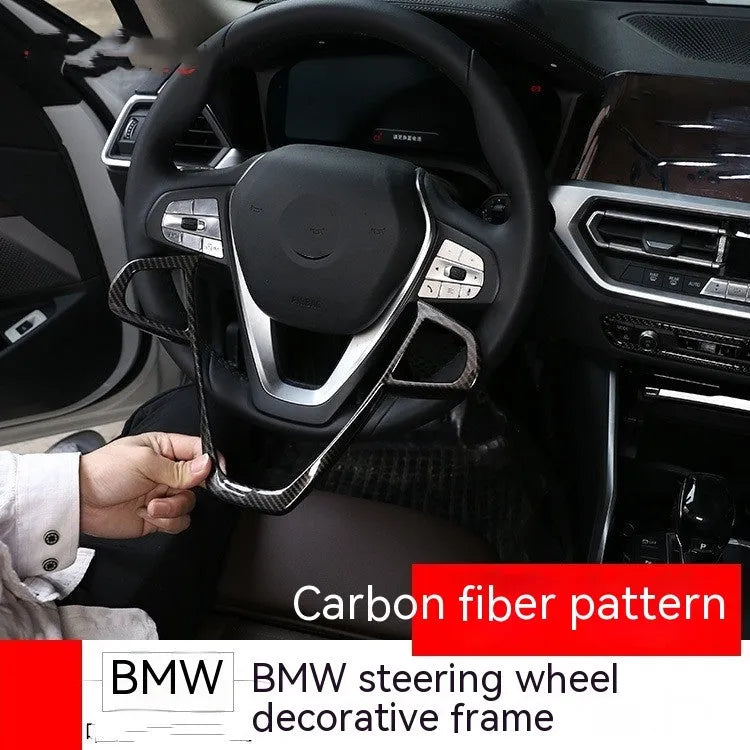 BMW steering wheel button frame decoration with carbon fibre pattern on black ABS.