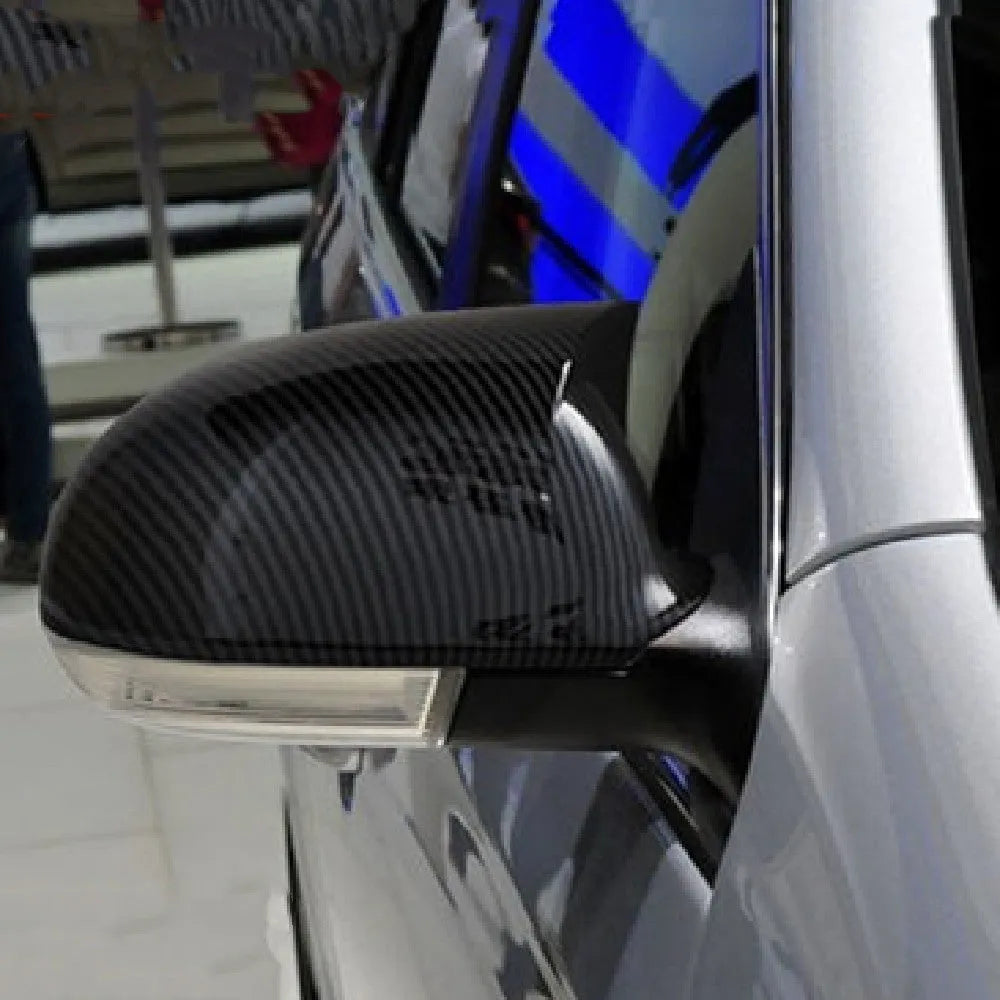 Pair of plastic outer reflector shells for Volkswagen Sagitar side mirrors in carbon fibre or bright black finish.