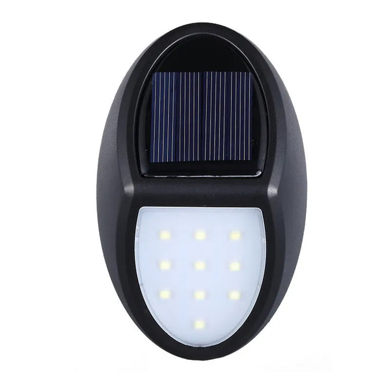 Black rectangular LED solar wall light mounted on an exterior wall for automatic night-time illumination.