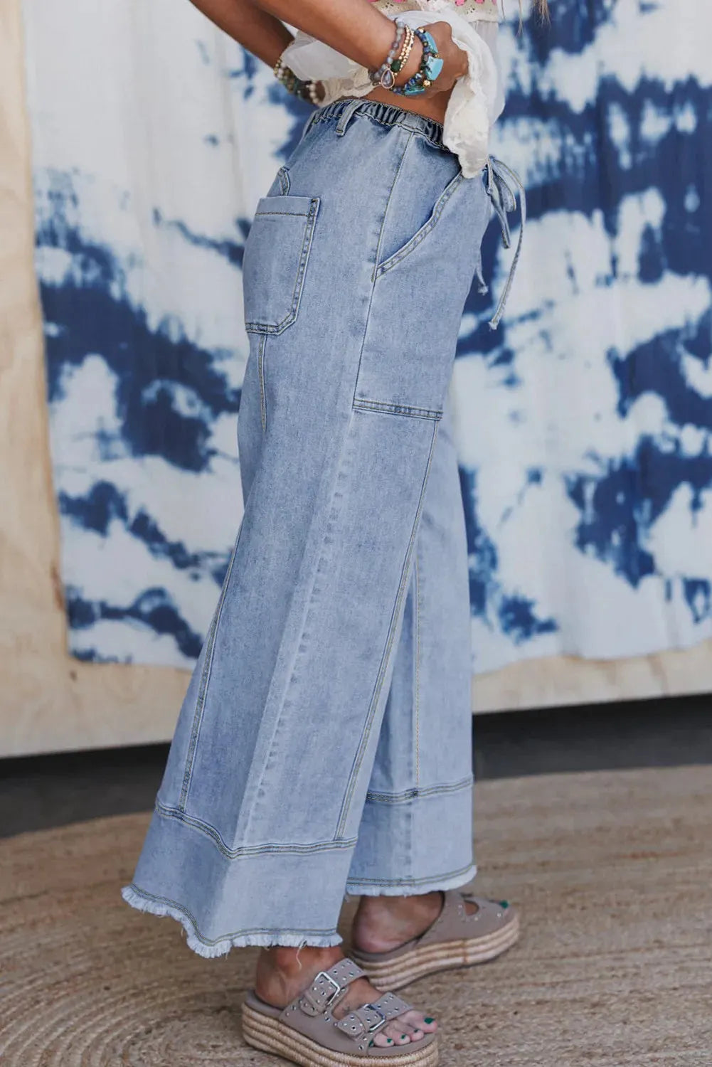 Beau blue wide leg denim pants with drawstring waist and raw hem seam detail