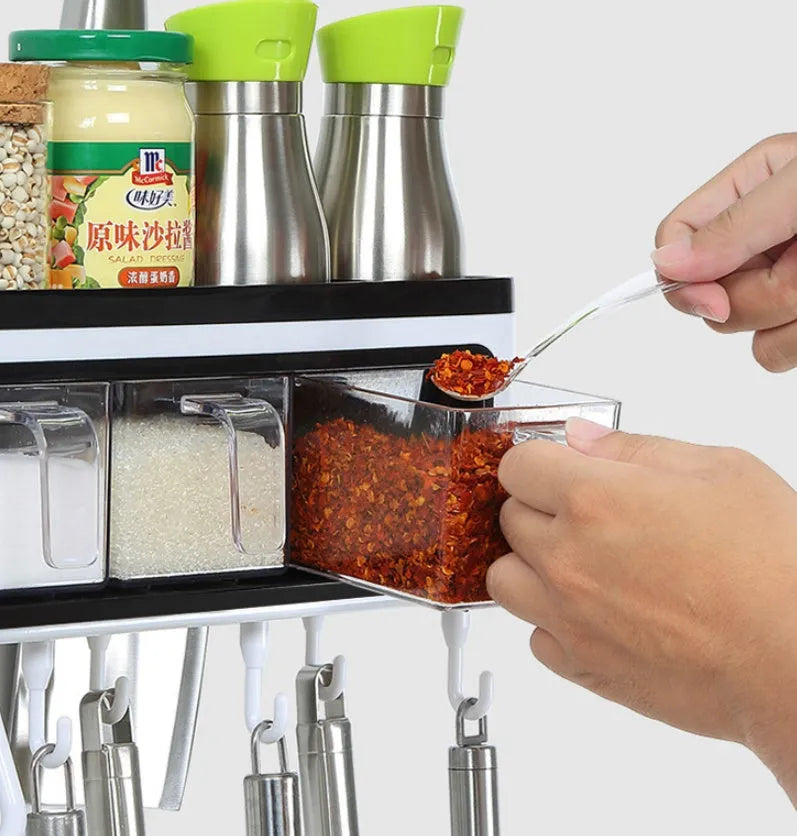 White plastic wall-mounted kitchen storage box with compartments for tools and seasonings