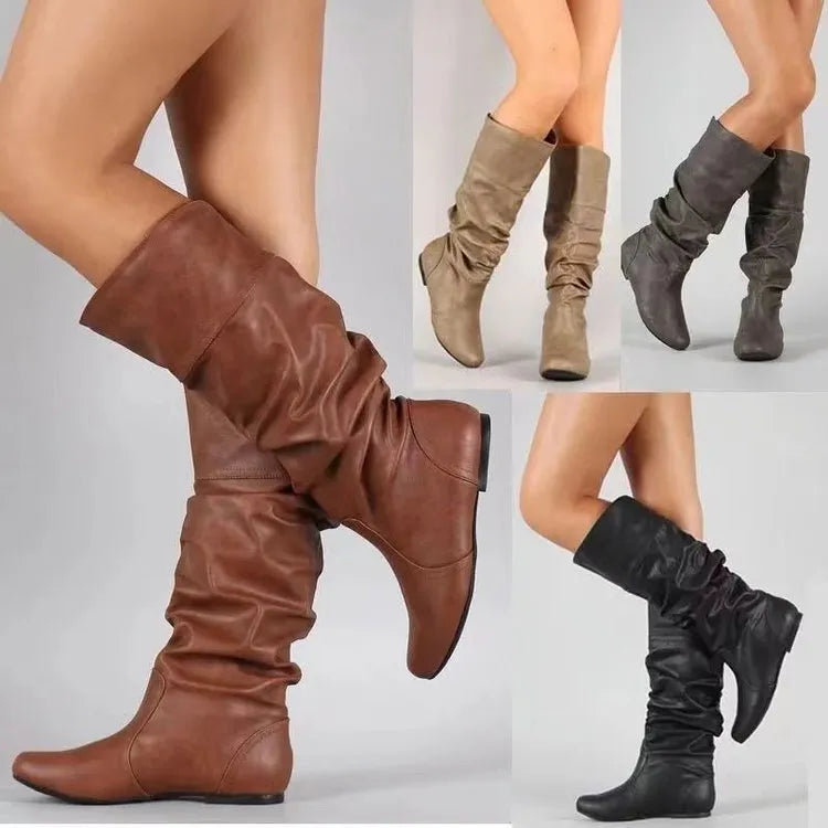 Women's flat heel black slip-on boots with round toe and high cylinder shaft.