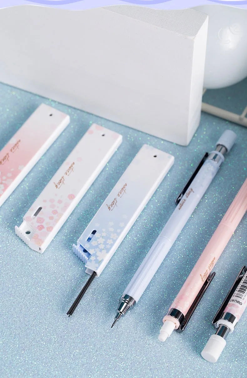 Mixed colour 0.5mm cartoon propelling pencils and HB refill boxes set on a white surface.