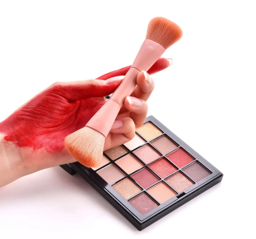 Ten cosmetic makeup brushes with wooden handles arranged showing various brush head shapes and sizes