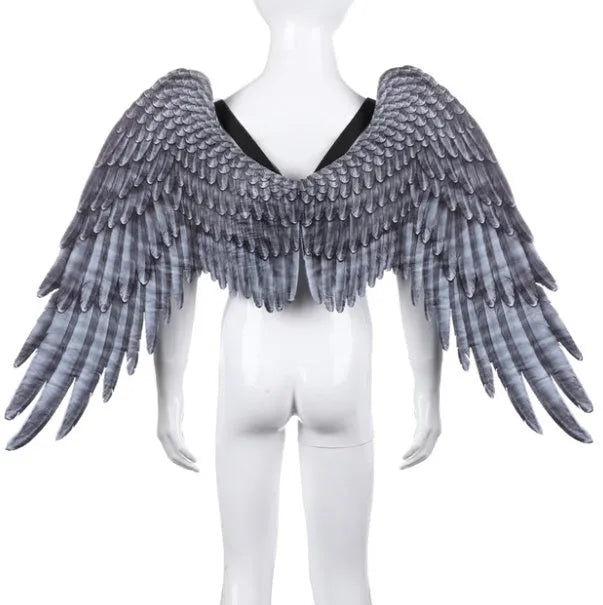 White 3D angel wings costume accessory made from non-woven fabric on child, 33cm by 68cm by 54cm