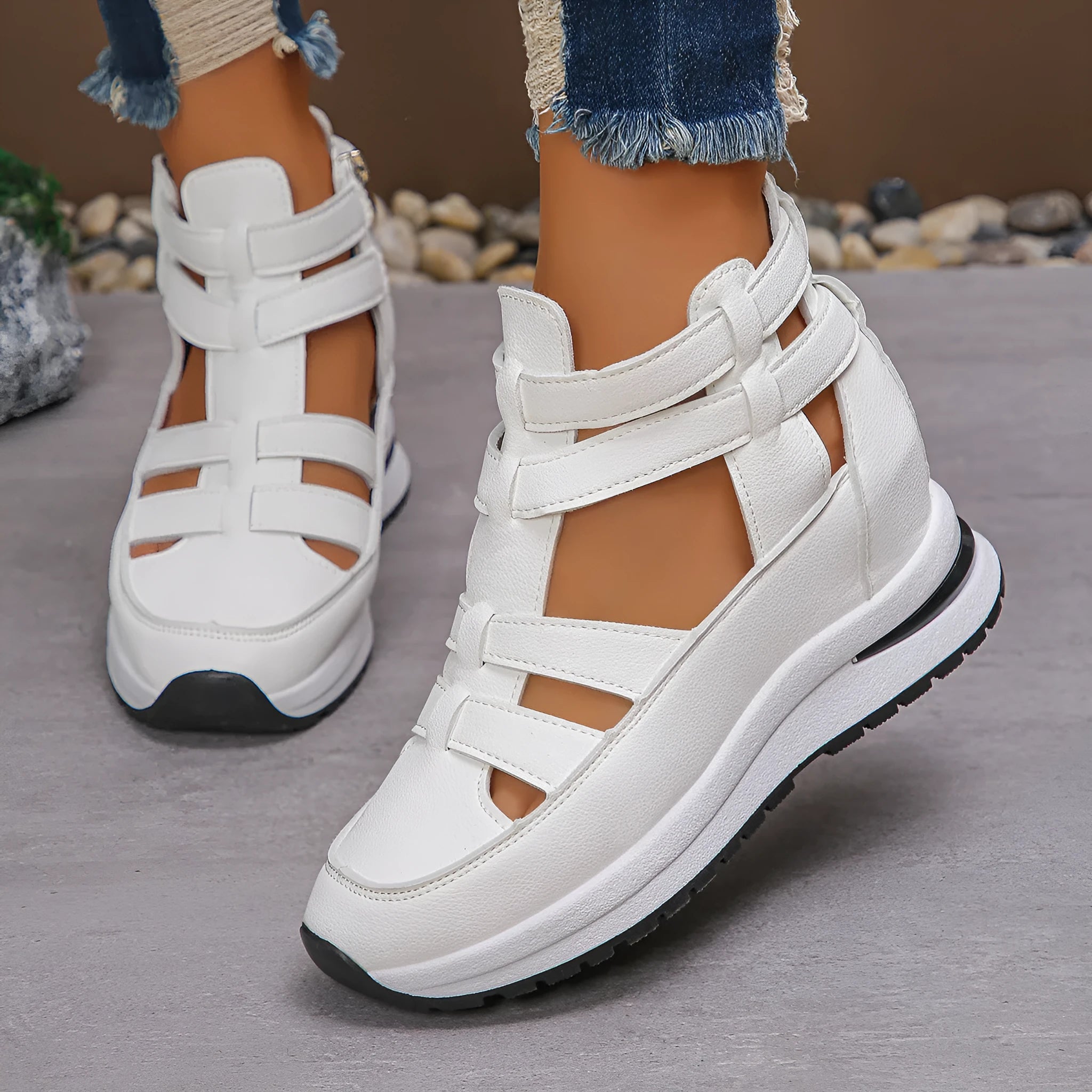 Women's black close-toed sandals with hollow-out patterning and platform sole, showing Velcro fastening