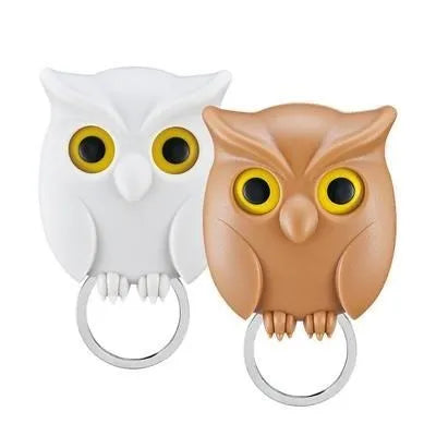 Magnetic wall key holder in white with attached keychains on a wall surface