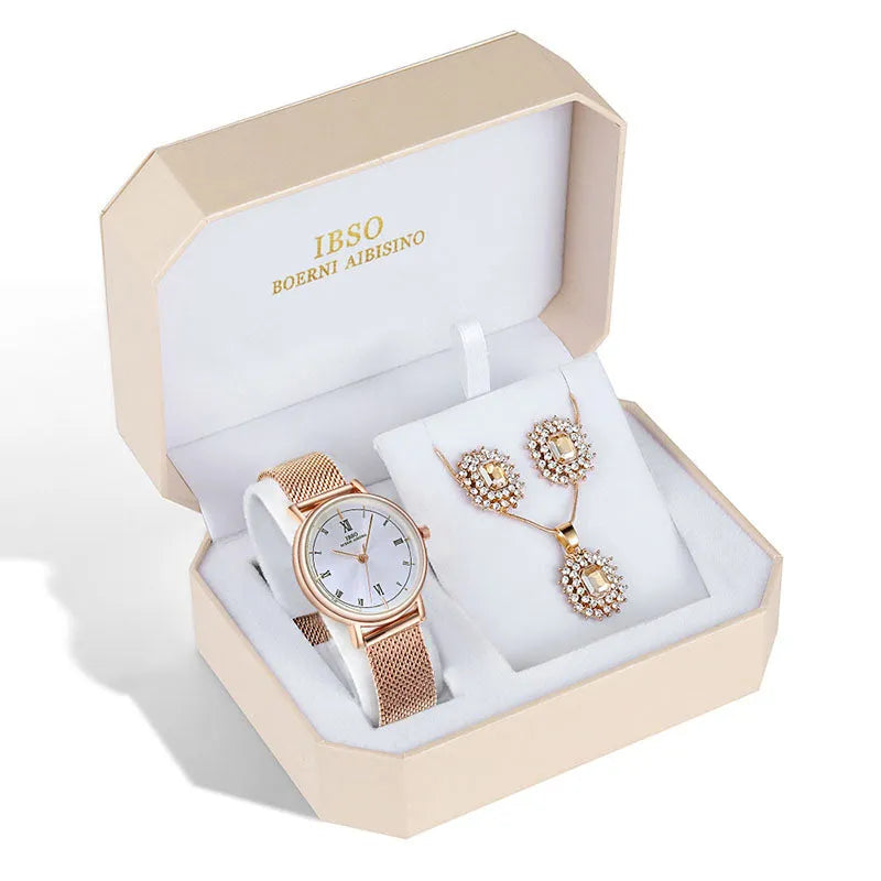 Women's quartz watch and jewellery set with 30mm dial, silver case, and stainless steel buckle, on a white background