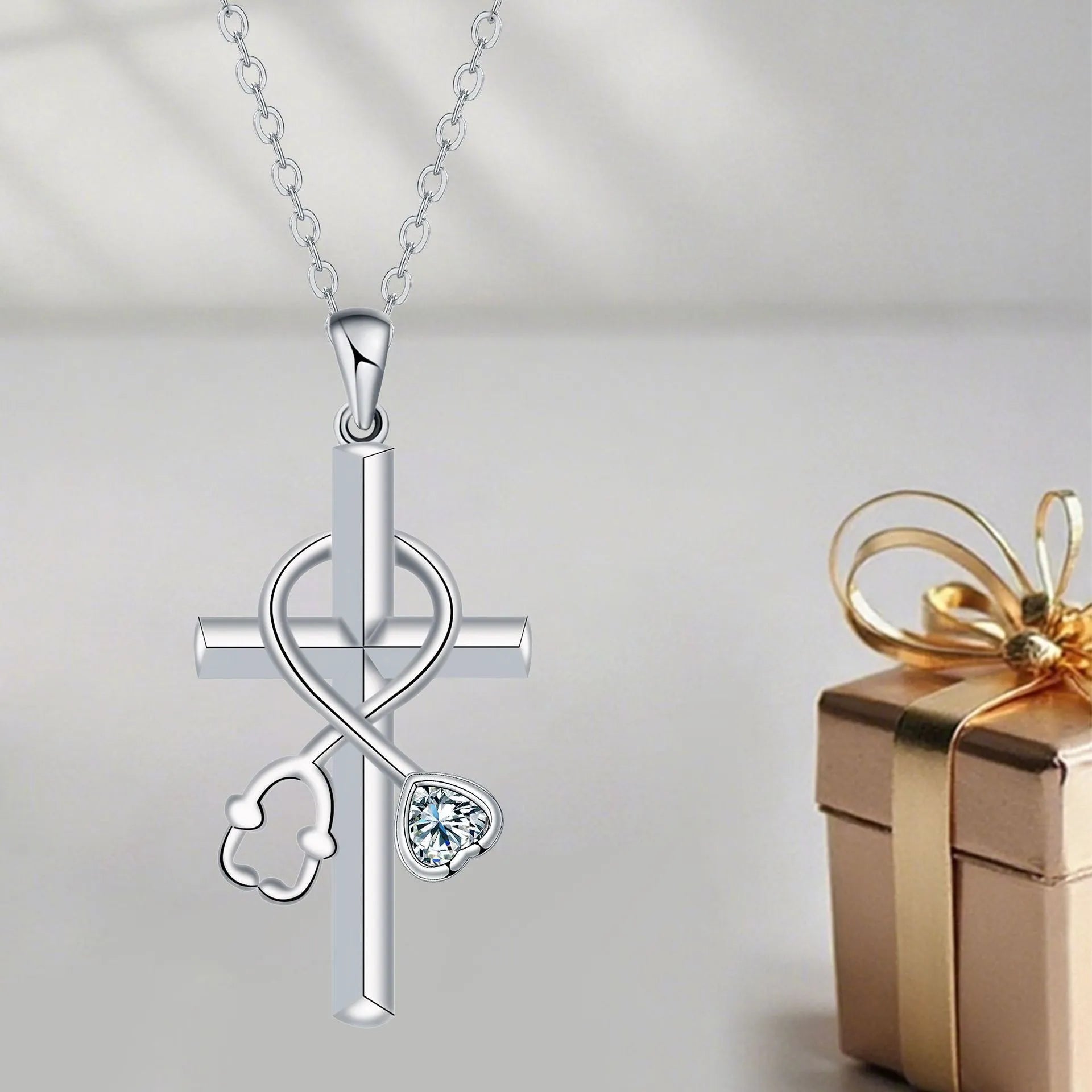 Copper cross necklace with a detailed stethoscope pendant on a chain.
