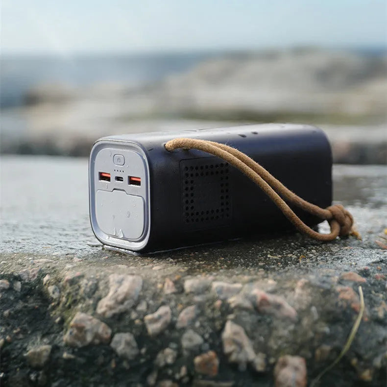 Black portable power bank with 220V AC output and solar charging panel, dimensions 70x70x162mm.