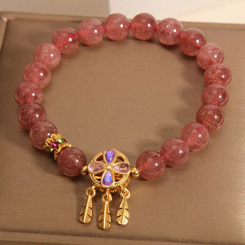 Women's strawberry quartz bracelet with four-leaf clover dream catcher ball pendant on adjustable leather cord