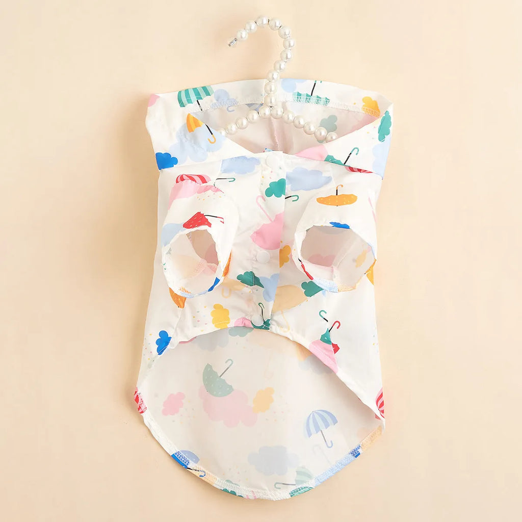 Colourful cartoon umbrella pattern pet raincoat for a small dog on a grey background.