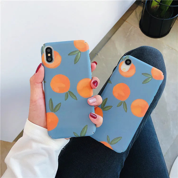Orange retro plastic iPhone case with water and blue background design on a table.