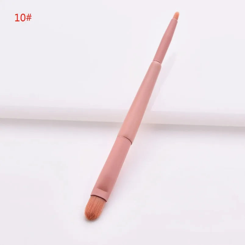 Ten cosmetic makeup brushes with wooden handles arranged showing various brush head shapes and sizes