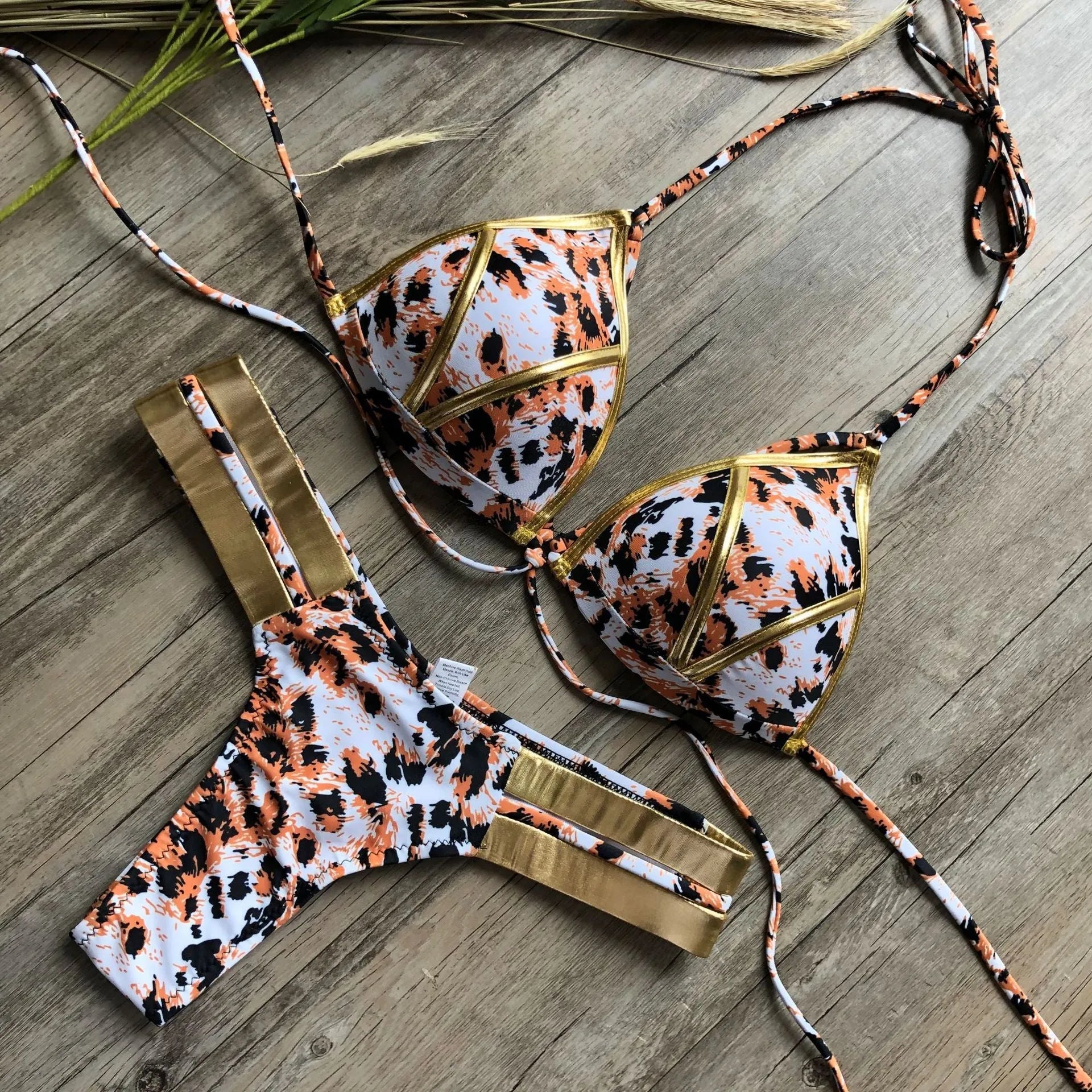 Women's bronzing bikini swimwear with padded cups, shown in a colour option like leopard print.