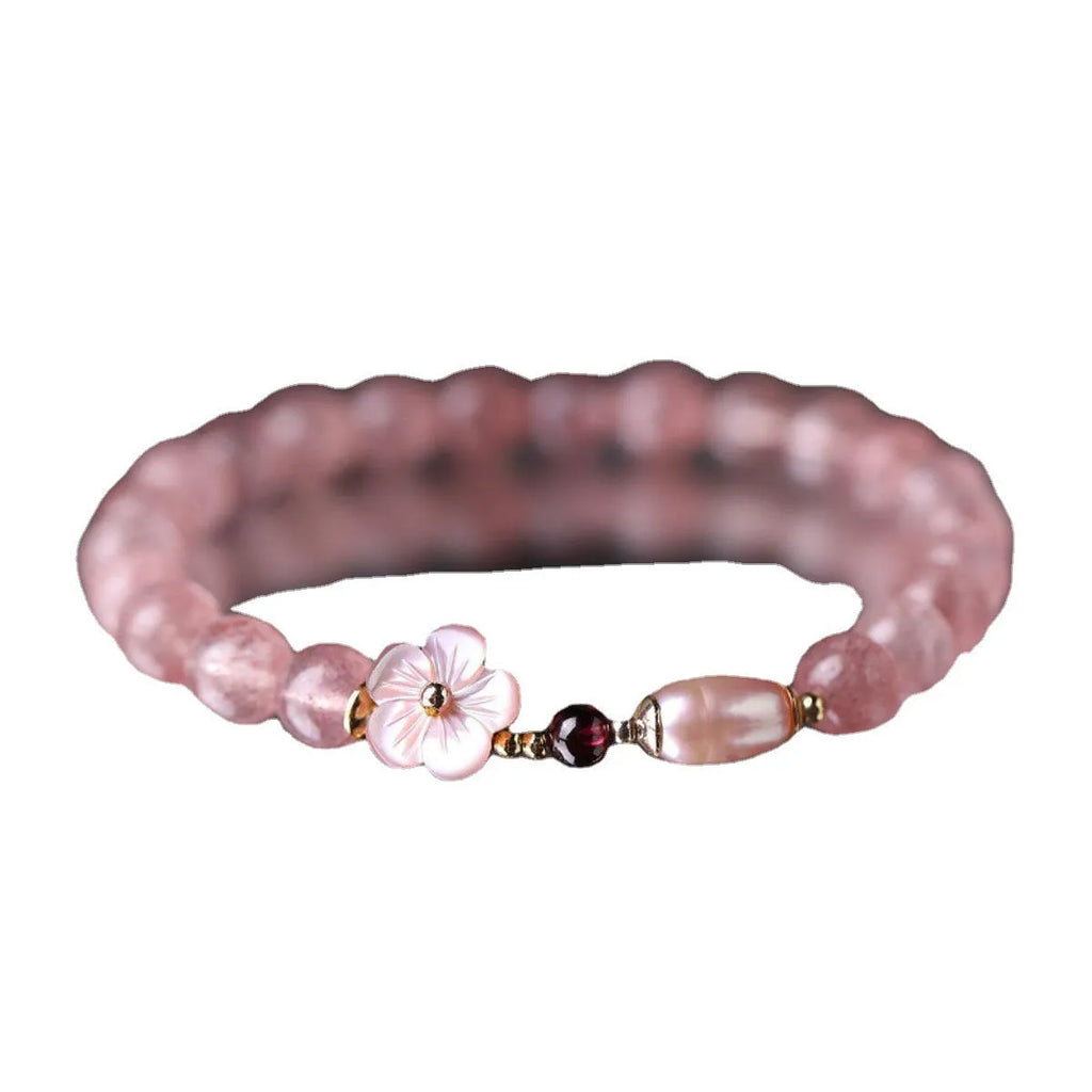 Strawberry quartz peach blossom crystal bracelet with floral design on wrist
