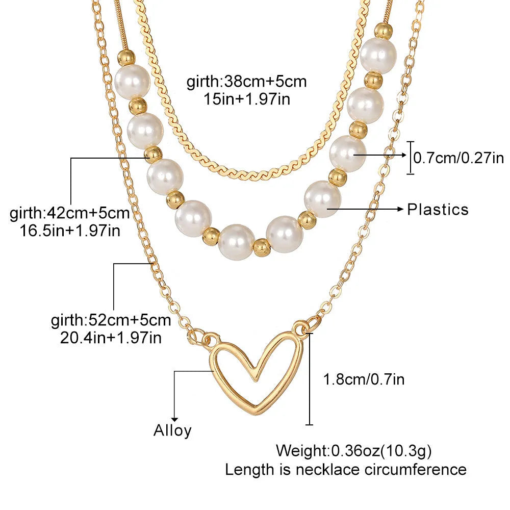 Vintage gold necklace with heart pendant on adjustable pearl chain, showing electroplated finish and love motifs