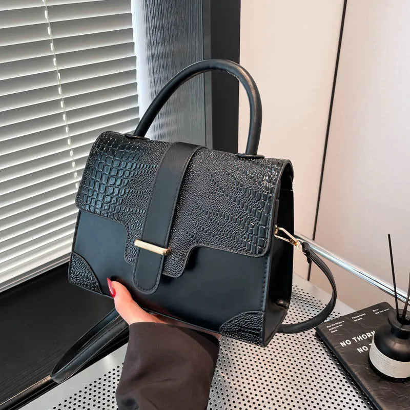 Ladies PU crossbody bag in black with single strap and medium-hardness shape