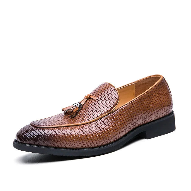 Men's black pointed slip-on leather shoes with a tassel detail on the low-top upper.