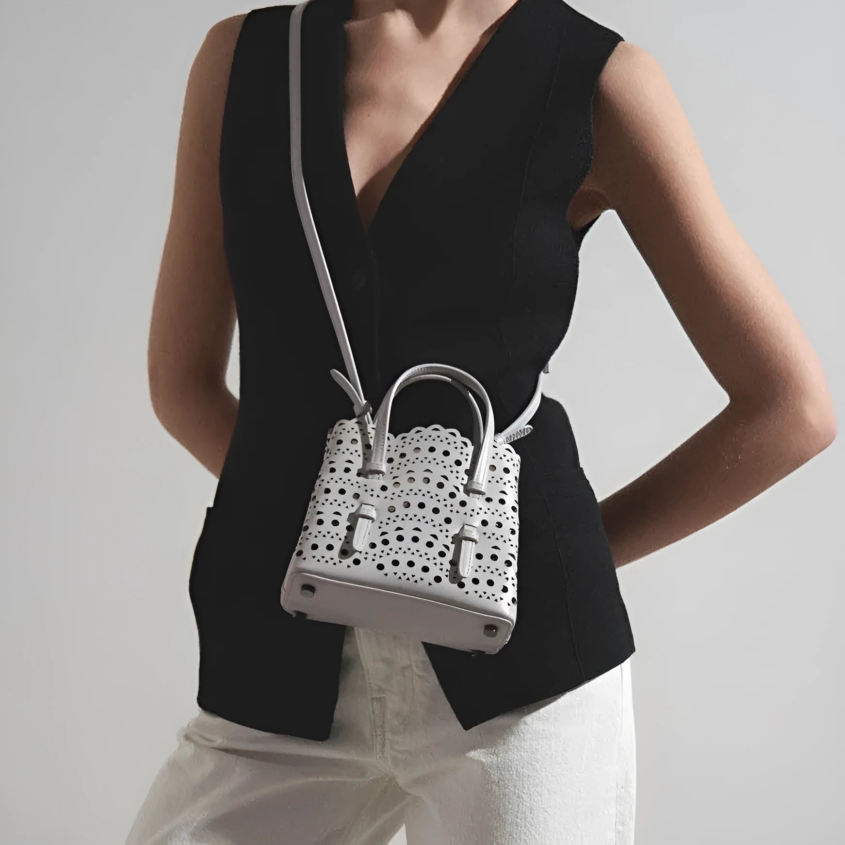 Hollow carved PU leather messenger bag in horizontal square shape with three shoulder straps