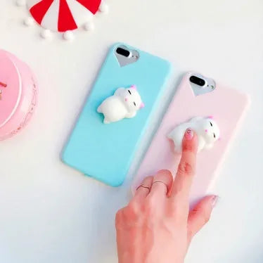 Soft pink silicone iPhone case with a raised 3D cartoon cat design on the back.