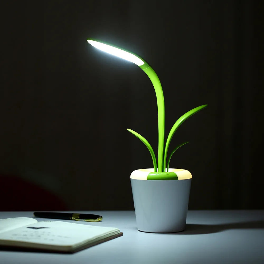 Modern rechargeable LED table lamp in blue with stylised plant shape on end table