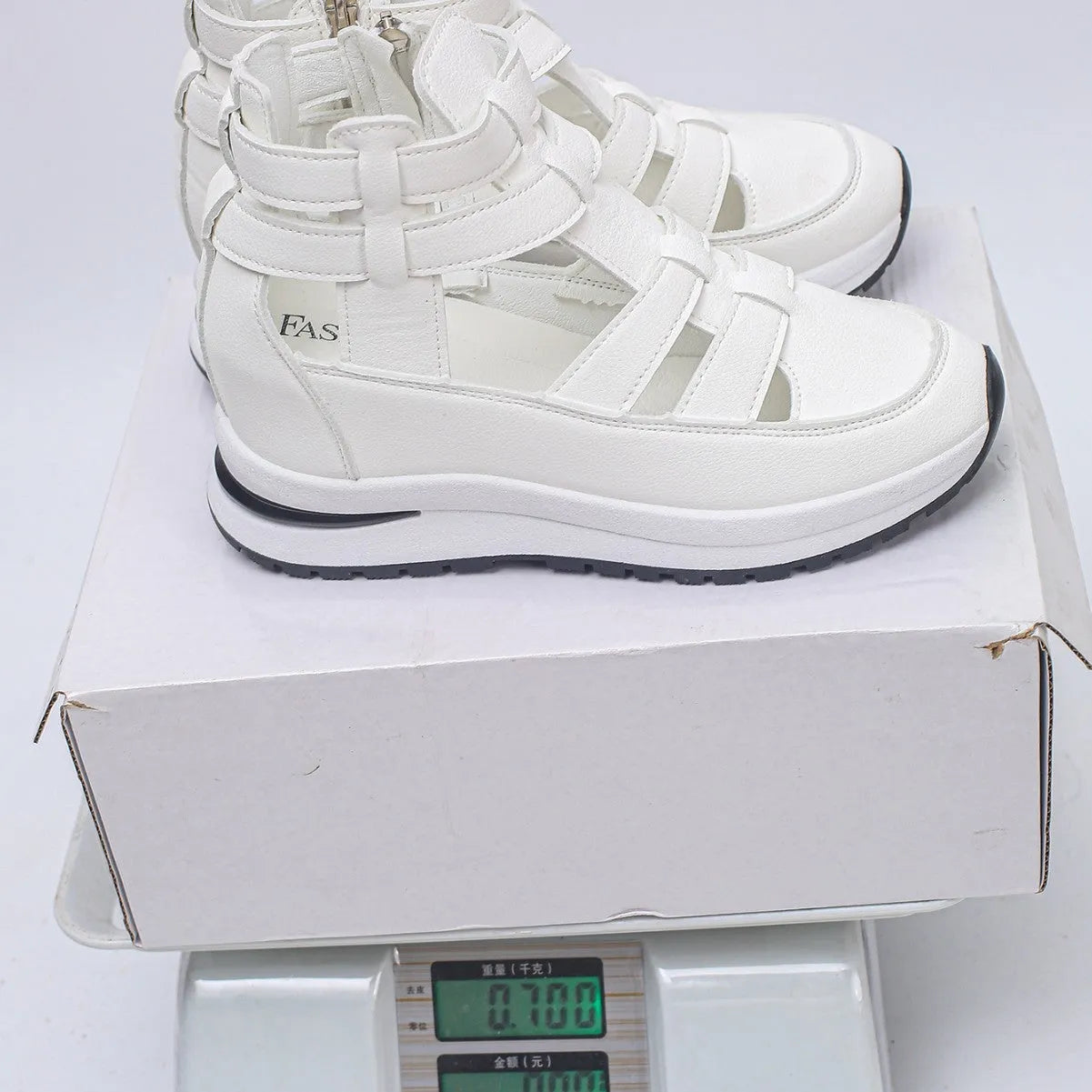 Women's black close-toed sandals with hollow-out patterning and platform sole, showing Velcro fastening