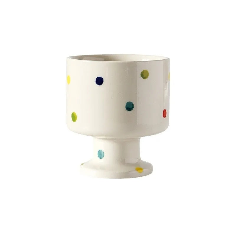 Hand-pinched irregular ceramic mug in a solid colour, shown from the side.