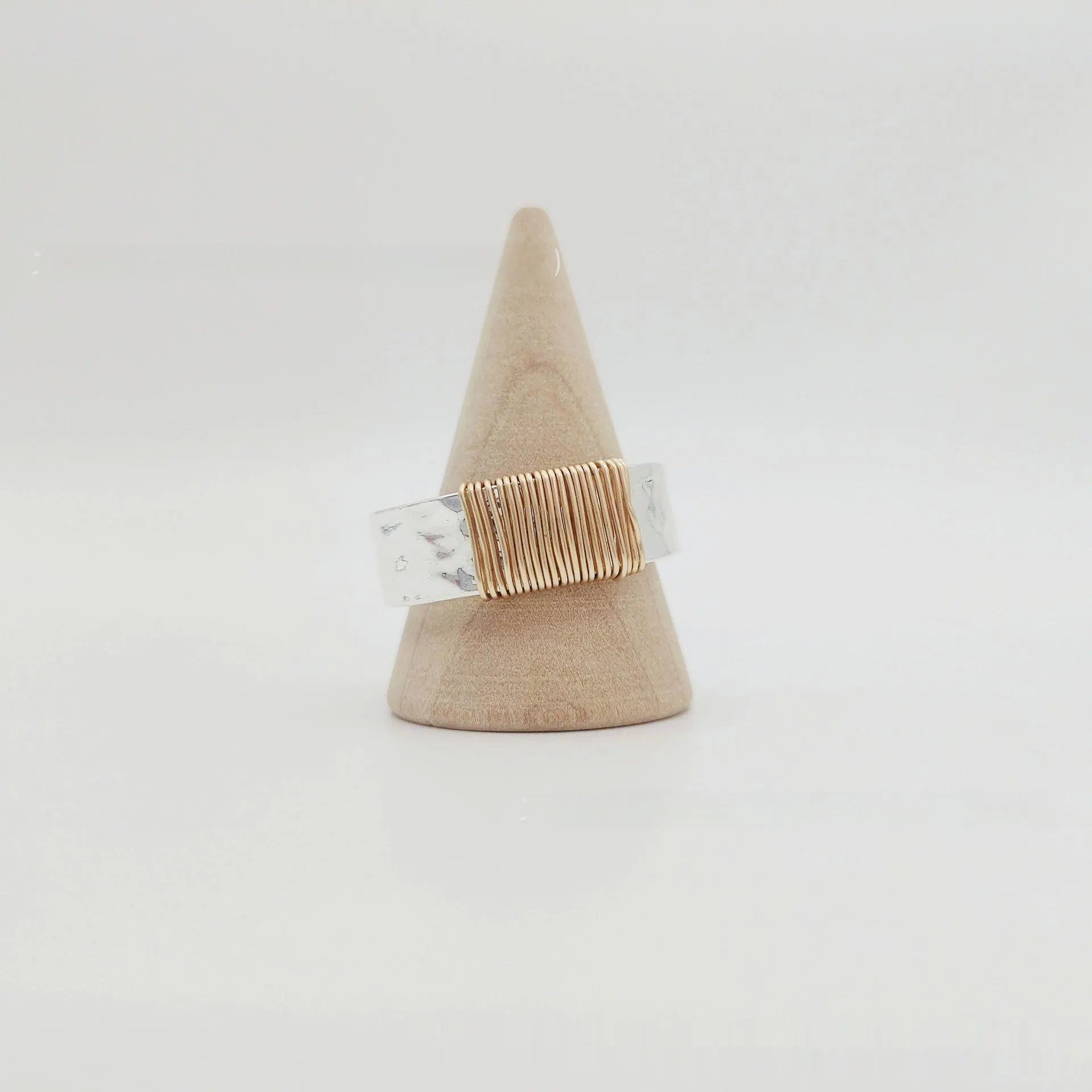 Simple geometric ring bracelet in electroplated copper with silver gold coil finish showing irregular coil design