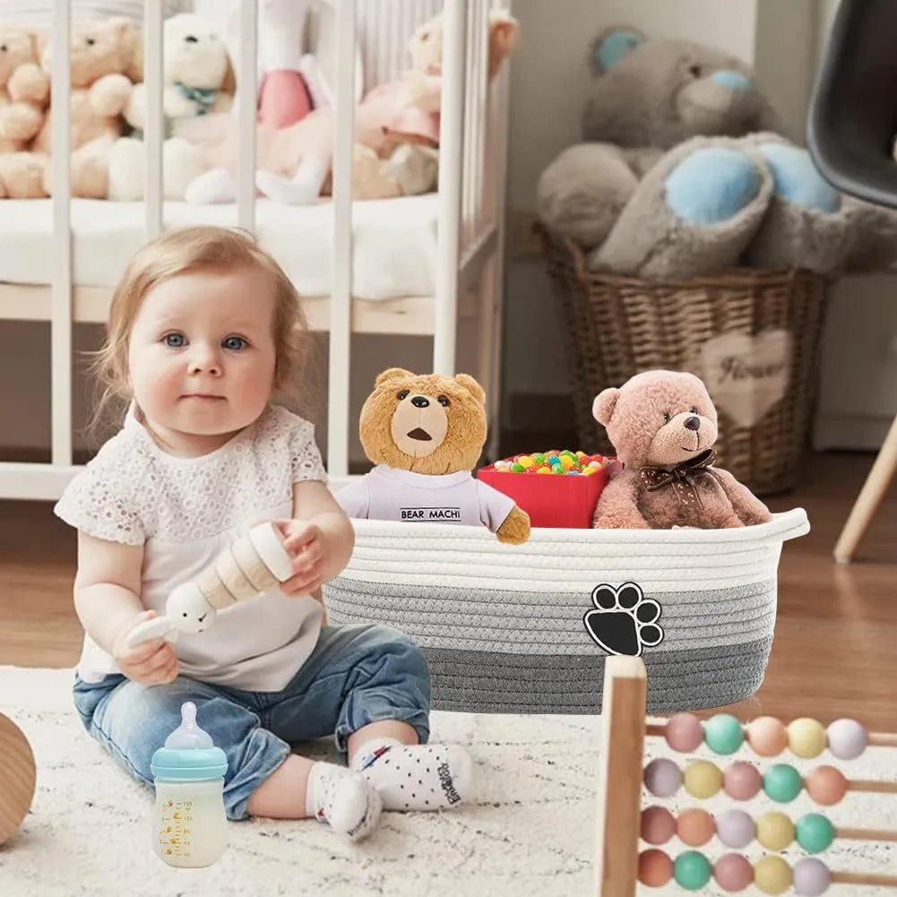 Hand-woven light beige cotton rope storage basket with wooden handle for home organisation