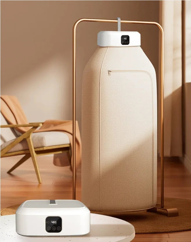 White cylindrical portable laundry drier with remote control on flat surface