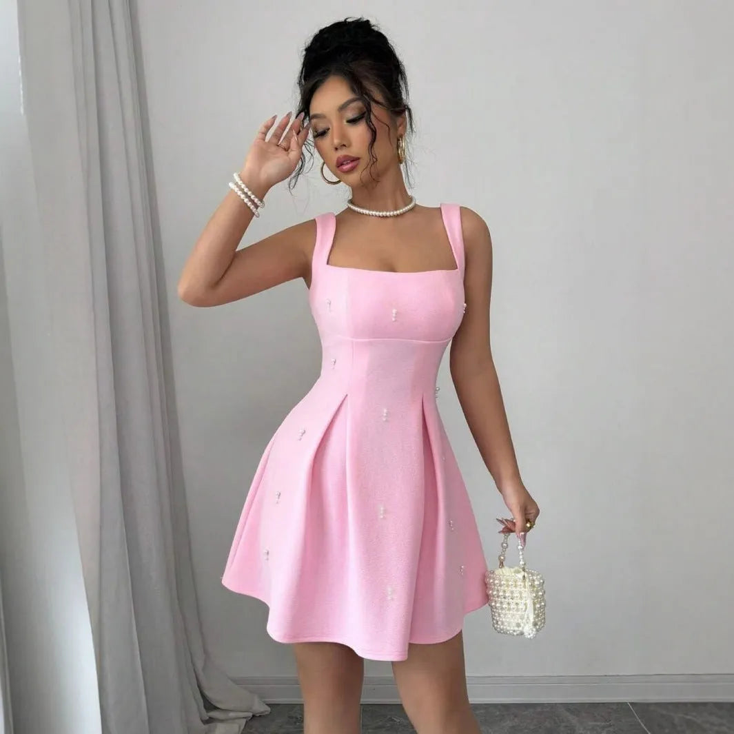 Pink high-waist A-line suspenders dress with short sleeveless skirt in polyester, shown on a model
