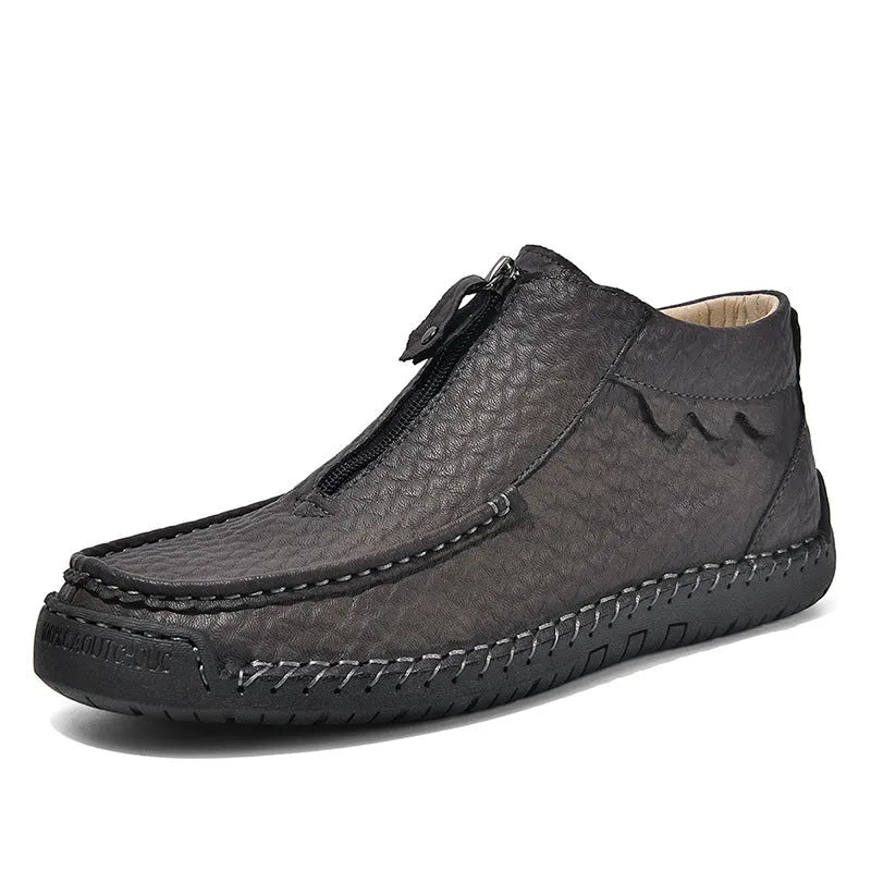 Men's black slip-on leather loafers with a round toe and rubber sole on a plain background.