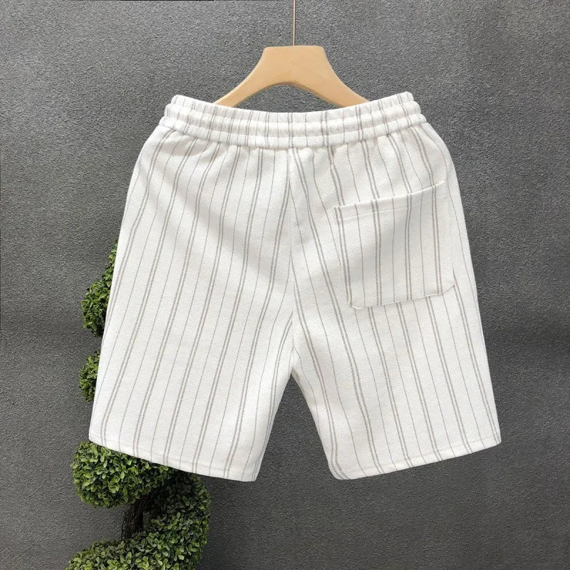 Man wearing black and white striped fleece-lined casual shorts with an elasticated waistband.
